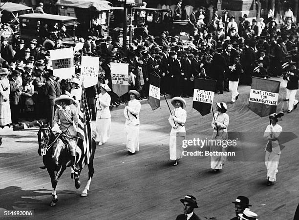 Grand Marshall Inez Milholland leads a procession of 30,000 marchers in New York during a suffragist parade.