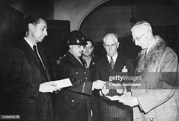 Nuernberg, Germany: Colonel B.C. Andrus presents letters certifying freedom to three of Hitler's yes-men. Nineteen other defendants were given terms...