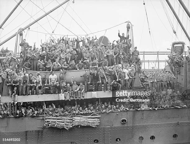 New York: Waving from the deck of the U.S.S. Washington as she arrived in New York Harbor today, June 11th, from Europe are some of the 1,593 naval...