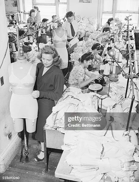 Clothing workers return to making girdles and brassieres at Flexes in the garment district of New York City at the end of World War II.