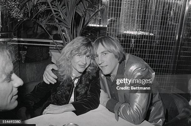 New York: French movie star Gerard Depardieu and his wife Elisabeth sit cheek to cheek during party celebrating the 5th anniversary of Regine's here...