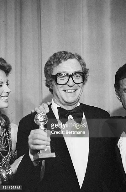 Hollywood: Michael Caine holds his Golden Globe award for best performance by an actor in a motion picture-drama presented by the Hollywood Foreign...