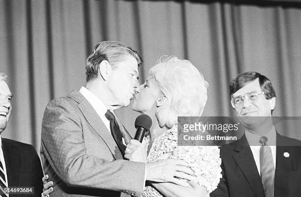 June 20, 1983-Jackson, Miss.: President Ronald Reagan gets a kiss from country music singer Tammy Wynette here 6/20 after she sang "Stands By Your...