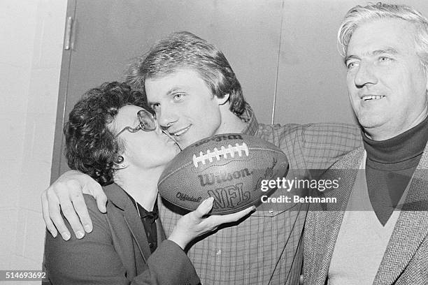 San Francisco 49er's quarterback Joe Montana receives a kiss from his mother, Theresa, after leading his team to victory against the Cincinnati...
