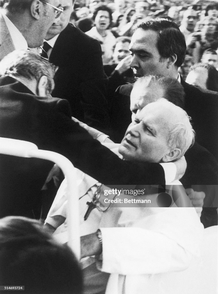 Aides hold Pope John Paul II after being shot by a terrorist. The ...