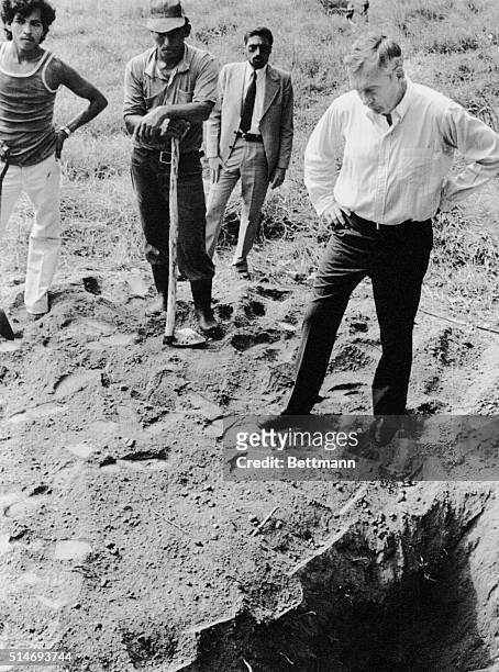 Santiago Nonualco, El Salvador: US Ambassador White examines the grave where four American nuns were found about 45 kms from the capital. The nuns...