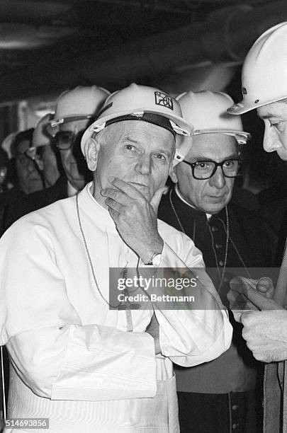 Pope John Paul II wears a hard hat while touring facilities and visiting workers at the Rosingnano Solvay chemical plant. | Location: Rosignano...