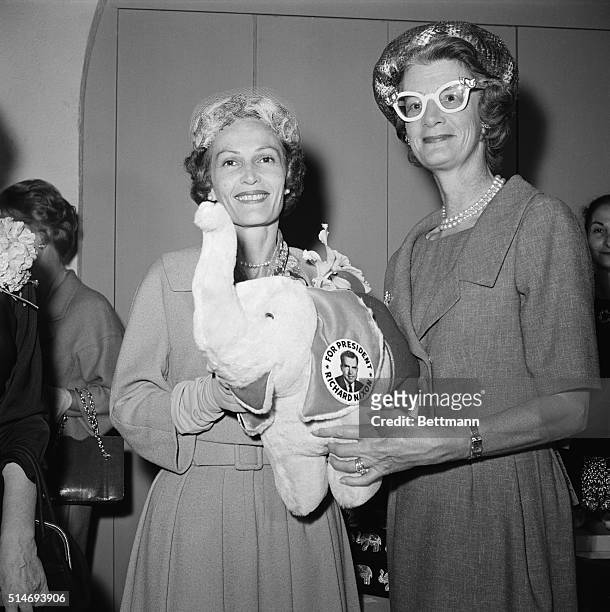 Pat Nixon, wife of Vice-President Richard Nixon, and Mary Todhunter Clark Rockefeller, wife of the New York governor Nelson Rockefeller, hold a toy...