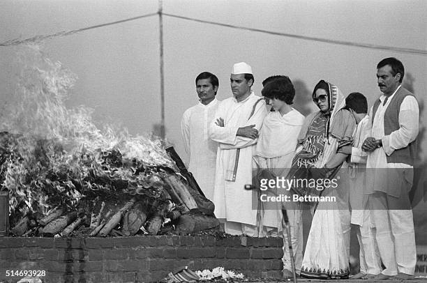 Indian Prime Minister Rajiv Gandhi, accompanied by his wife Sonia and his daughter Priyanka, attends the cremation of his mother, former Prime...