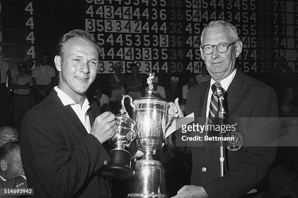 President John Cook presents golfer Arnold Palmer with the trophy for winning the 1960 U.S. Open golf tournament in Denver, Colorado. June 18, 1960.