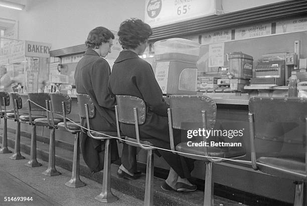 Women at a roped-off lunch counter stage a sit down to protest segregation in Nashville, Tennessee.