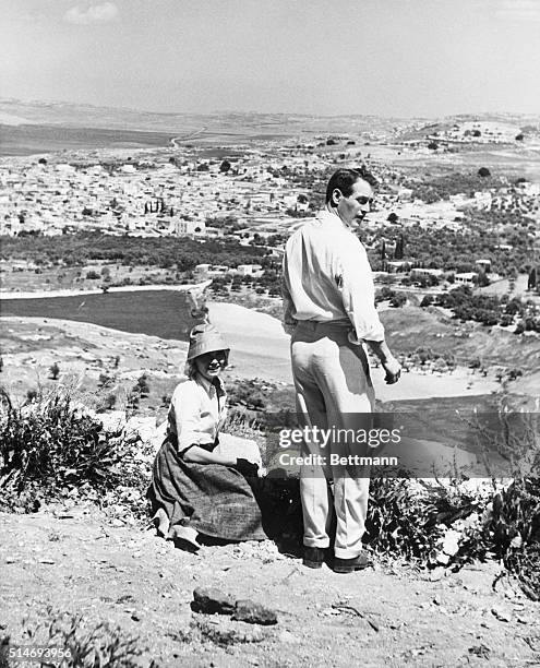 Eva Marie Saint and Paul Newman relax between scenes while Exodus, on a hill overlooking the town of Kfar Kana .