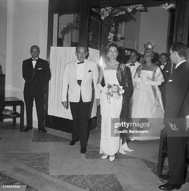 Grace Kelly, the Princess of Monaco, attends a Red Cross benfit with her husband Prince Rainier at the International Sporting Club.