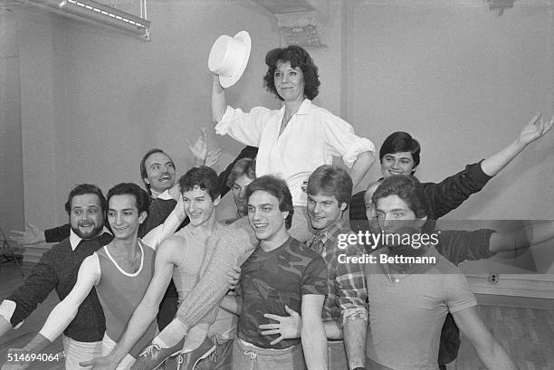 British film star Diana Rigg concludes a singing and dancing number with members of the male chorus while rehearsing for her American musical debut...