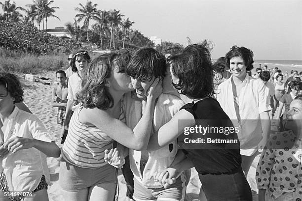 The Beatles drummer Ringo Starr gets kisses from excited fans when he spends a day at Miami Beach, Florida.