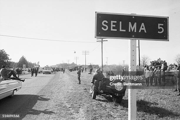 With National Guardsmen on the roadside, civil rights marchers begin the 50 mile march to Montgomery, Alabama to protest race discrimination in voter...