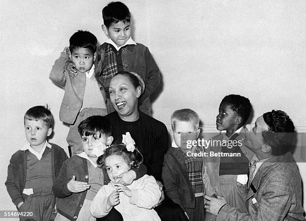 Singer Josephine Baker with her husband Joe Bouillon and their eleven adopted children of all races at their home in Les Milandes, France. |...