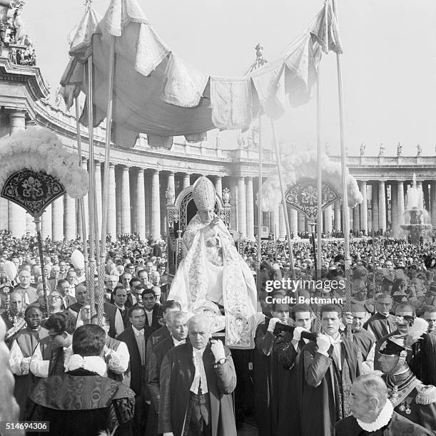 Pope John XXIII is carried ceremoniously to St. Peter's Basilica for the inauguration of the 21st Ecumenical Council, the Second Vatican Council,...