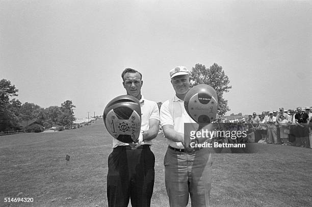 Golfers Arnold Palmer and Jack Nicklaus check their driver clubs before teeing off for a tie breaking playoff in the 1962 US Open.