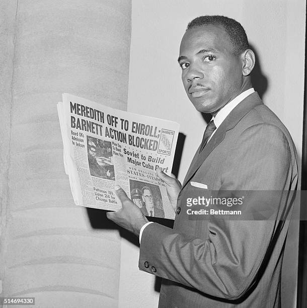 James Meredith, the first African American student to enroll at the University of Mississippi, holds a newspaper as he attempts to register at the...