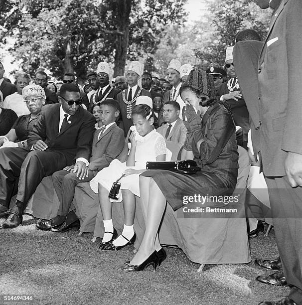 At the funeral of slain civil rights leader Medgar Evers, Charles Evers, brother of Medgar, leans over to comfort Medgar's widow Myrlie and her...