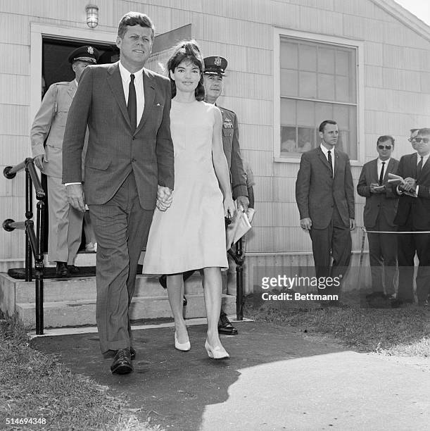 President Kennedy holds hands with his wife Jackie as they leave the Otis Air Force Base hospital on August 14 where Mrs. Kennedy gave birth on...