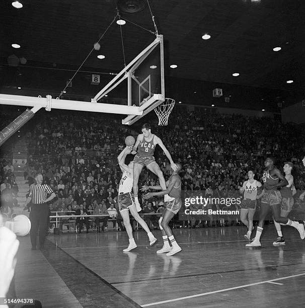 In the 1964 Olympic trials, Bill Bradley of Princeton fouls Lloyd Sharrar as he tries to make a basket.