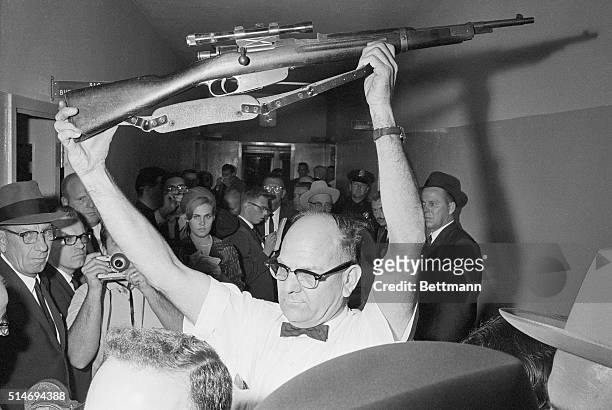 Dallas policeman holds up the rifle used to kill President John F Kennedy on November 22, 1963. Lee Harvey Oswald has been charged with the murder. |...