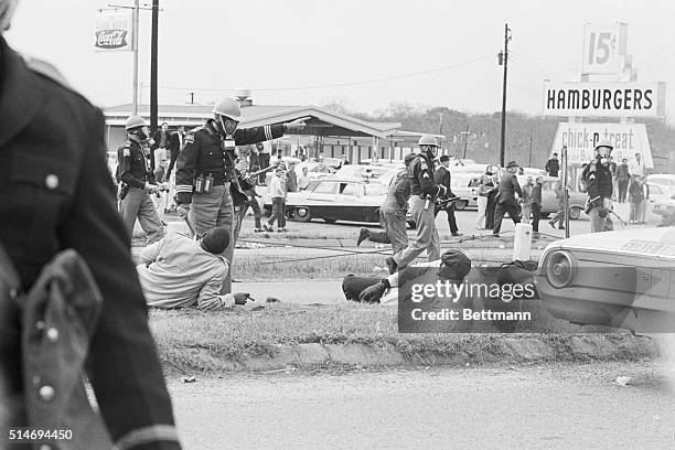 Police officers attack civil rights marchers in Selma, Alabama who were attempting to begin a 50 mile march to Montgomery to protest race...