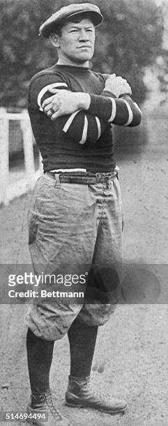All-around athlete Jim Thorpe stands in the street with his arms crossed. Thorpe excelled as a football player, baseball player and won the gold...