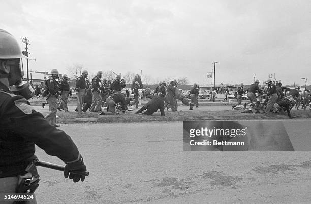 Police officers attack civil rights marchers in Selma, Alabama who were attempting to begin a 50 mile march to Montgomery to protest race...
