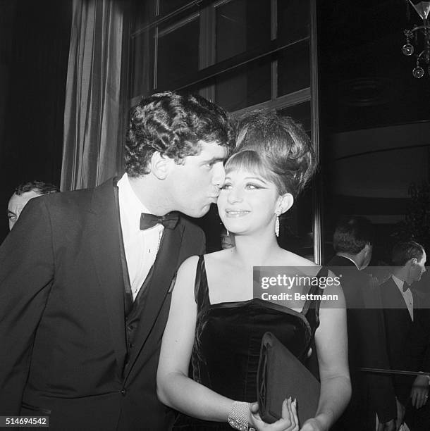 Singer Barbra Streisand receives a kiss from her husband Elliott Gould at a celebration party for the cast of Funny Girl at the Rainbow Room in New...