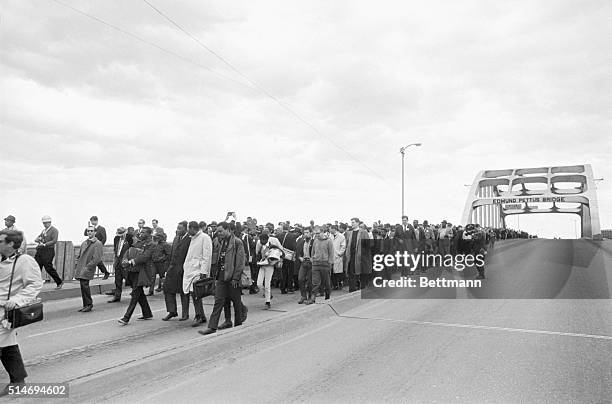 Civil rights marchers led by Martin Luther King, Jr. Cross the Edmund Pettus bridge in Selma, Alabama after being turned back by state troopers. The...