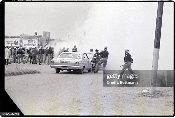 Police officers attack civil rights marchers with tear gas in Selma, Alabama. The marchers were attempting to begin a 50 mile march to Montgomery to...