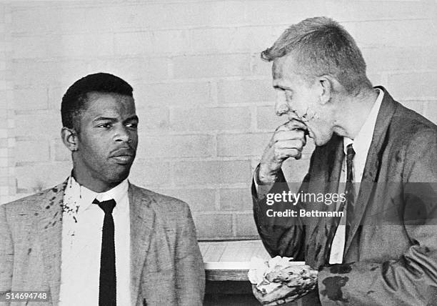 Two blood-splattered Freedom Riders, John Lewis and James Zwerg stand together after being attacked and beaten by pro-segregationists in Montgomery,...