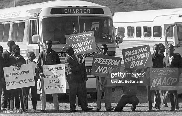 Marchers holding signs gather at school athletic field in Tallahassee, Florida before a Civil Rights march.