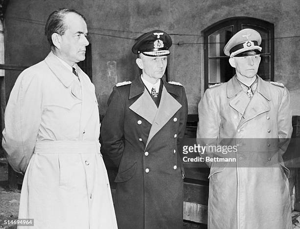 Flensburg, Germany: Admiral Karl Doenitz, successor to Adolf Hitler as Germany's Fuehrer, stands between Reich Production Minister Albert Speer and...