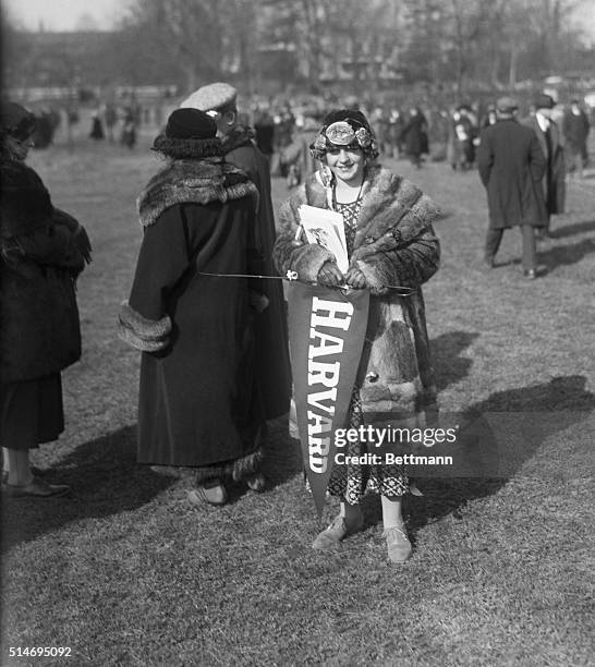 Young woman holds a Harvard pennant at Princeton University during a football game between the two schools in 1923. Harvard won by 5 points.