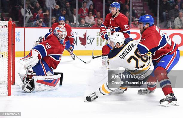 Mike Condon of the Montreal Canadiens stops a shot by Zemgus Girgensons of the Buffalo Sabres in the NHL game at the Bell Centre on March 10, 2016 in...