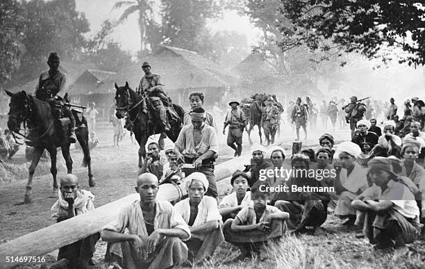 Burma-Natives, gathered by the roadside in the town of Maltaban, in Burma, to watch the invading Japanese march through on their way to Rangoon,...