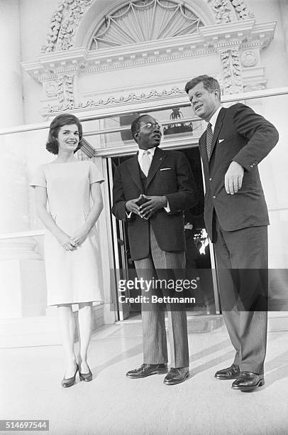 Washington, DC: Arrives for luncheon. President Kennedy and the First lady greet President Leopold Sedar Senghor of Senegal as the latter arrives for...