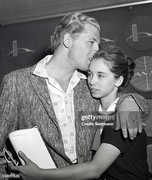 Jerry Lee Lewis kisses his new wife, Myra Gail, as they arrive at Idlewild Airport in New York City on May 28, 1958. Earlier in London, Myra, who is...