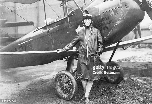 Photo shows Miss Amy Johnson, the young Yorkshire air woman, beside her plane at Croyden Airport, England. Filed May 13th, 1930.