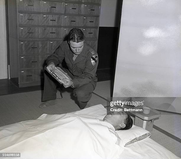 Tokyo, Japan: The body of Prince Fuminaro Konoye, one of Hirohito's closest war time advisers, is being examined by Captain Charles F. Sewell, of...