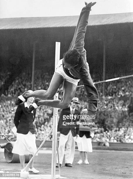 Alice Coachman, woman high jumper from Albany, GA, is shown as she cleared the bar with an Olympic record breaking leap of 5 feet, 6 1/8 inches. She...