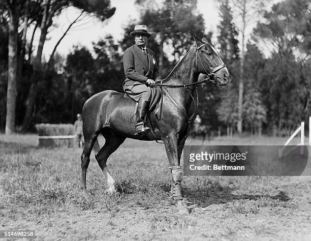 Fascist dictator Benito Mussolini rides a horse on the grounds of his villa in Rome.