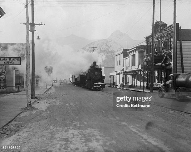 Skagway, AL:The engine and trains of the White Pass and Yukon railway line running through Broadway which is the only link between the Alcan highway...