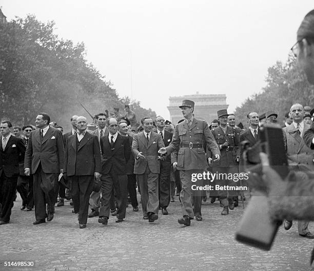 General Charles de Gaulle leads a triumphant procession down Champs-Elysees as part of the celebration of the liberation of Paris. To the right of de...