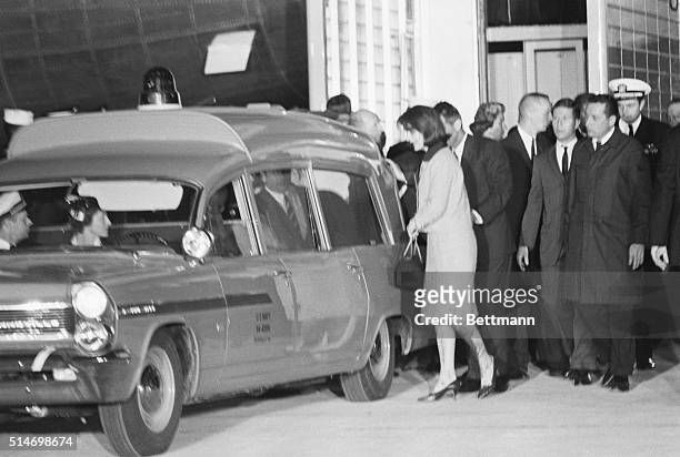 First Lady Jacqueline Kennedy stands behind the ambulance containing her husband's corpse, on November 22, 1963. President Kennedy was assassinated...