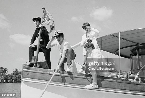 The Beatles, John Lennon, Paul McCartney, George Harrison, and Ringo Starr , on the bow of a boat in Miami Beach.